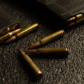 Rifle cartridges and a magazine on a textured mat